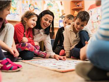 image of teacher playing games with children